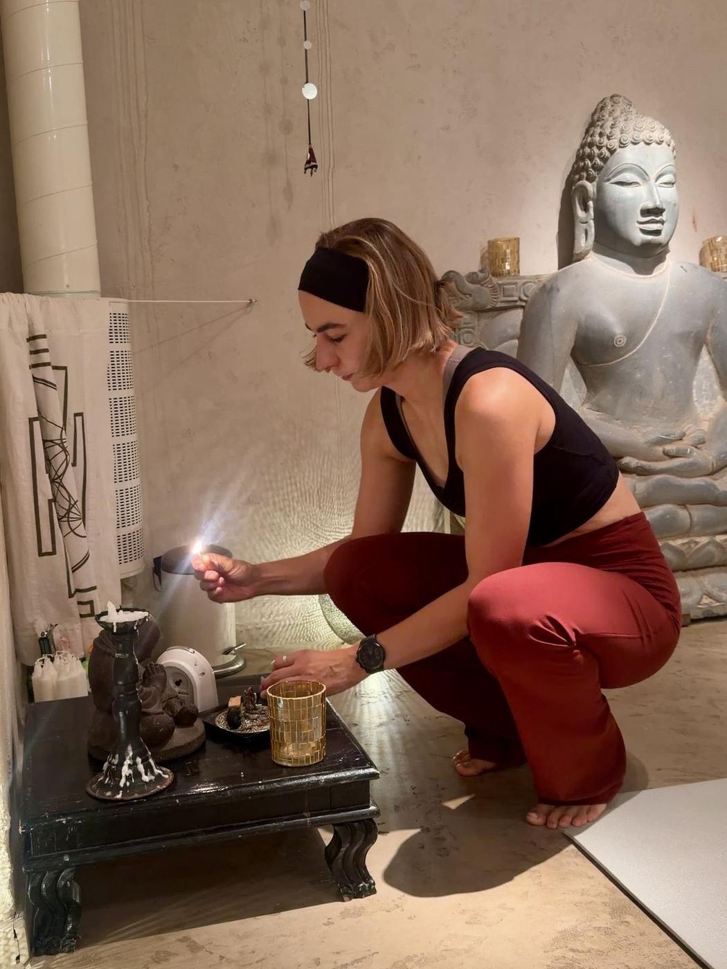 Camilla Tilly, yoga teacher in Stockholm, lighting a candle before practice